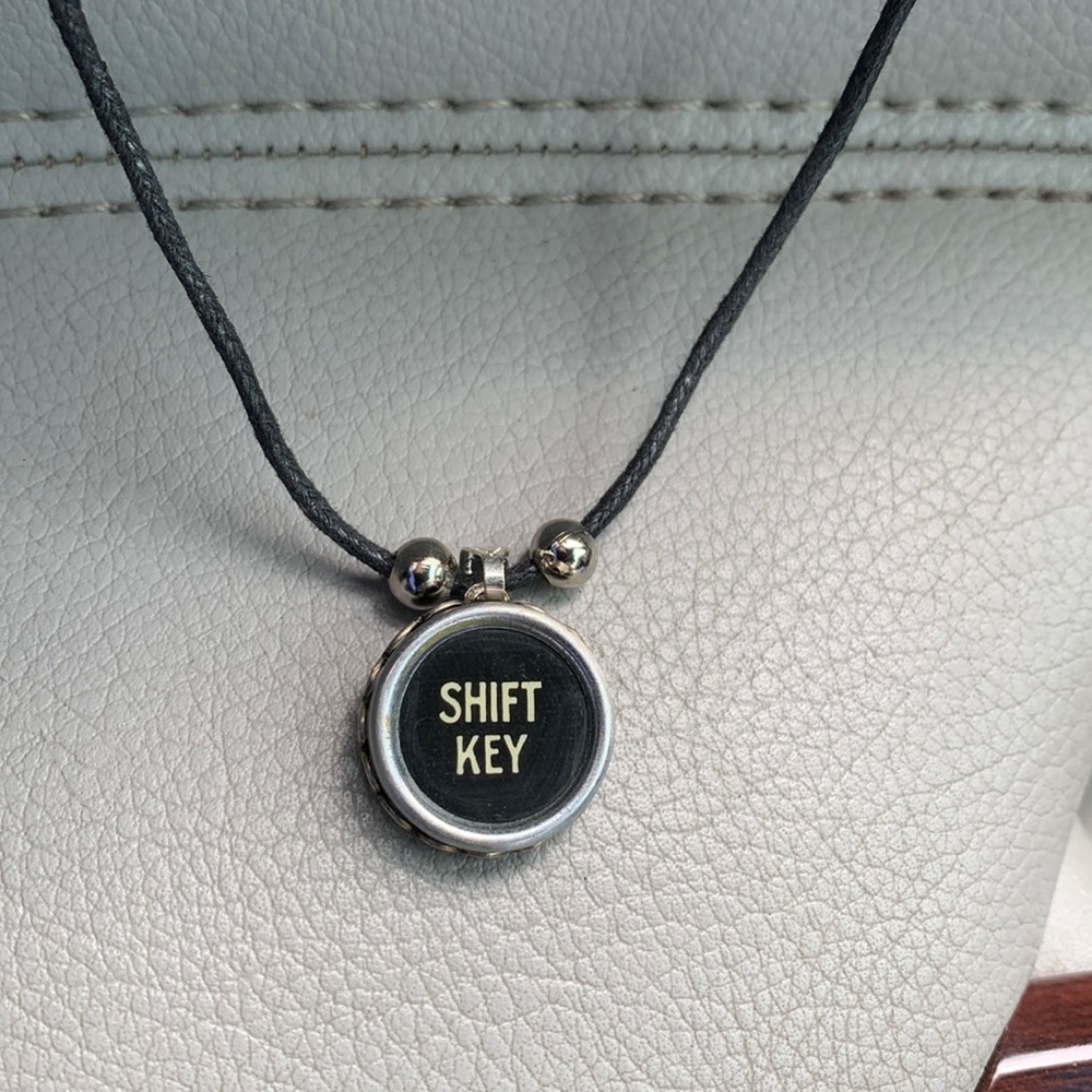 Shift key typewriter key pendant on black cord